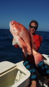 First mate Caleb showing off a slob red snapper for the viewers